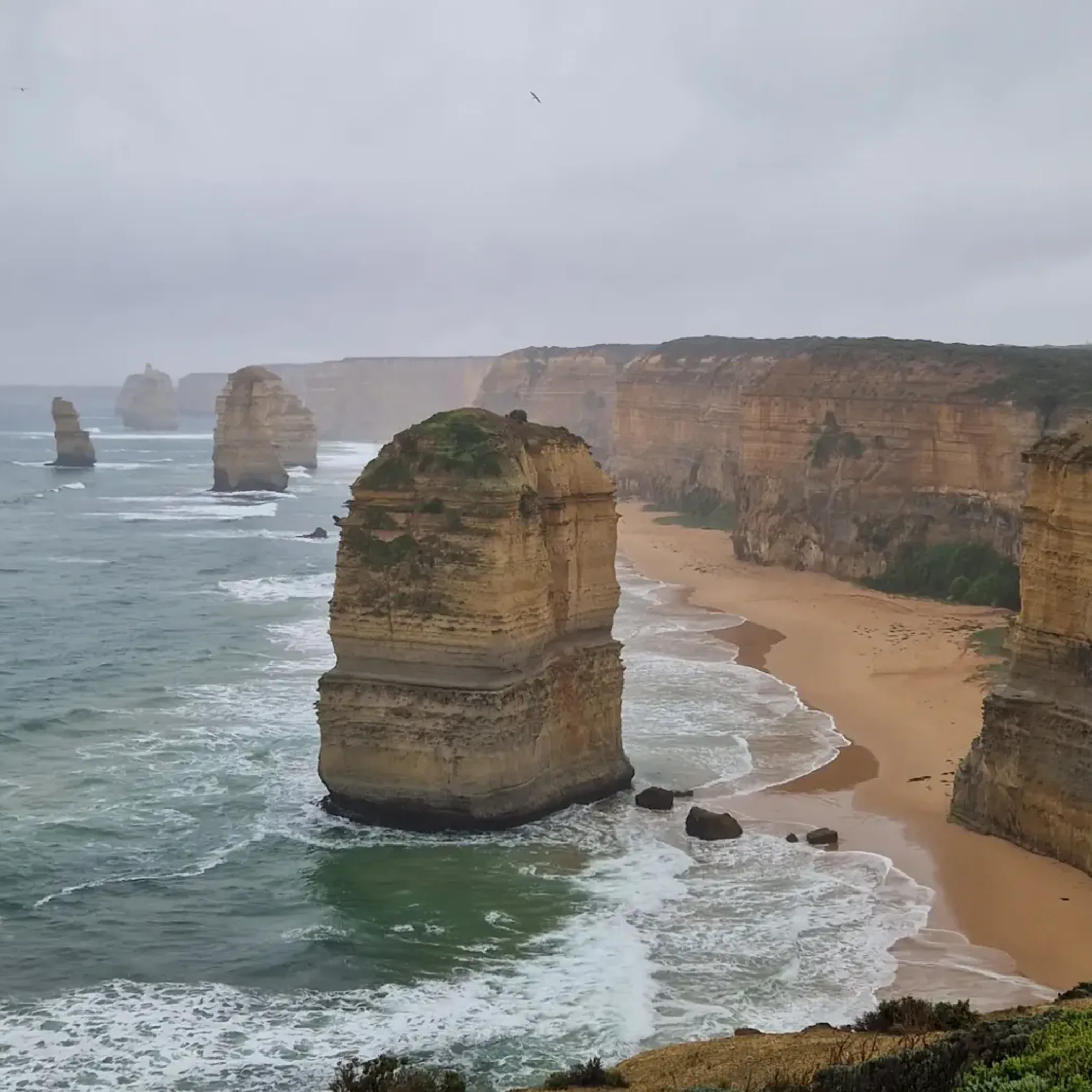 driving along winding great ocean road cliffs